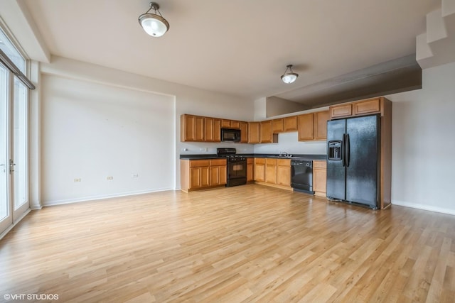 3630 N Harlem Ave Unit 410, Chicago, IL 60634 - kitchen with black appliances, dark countertops, a sink, and plenty of natural light