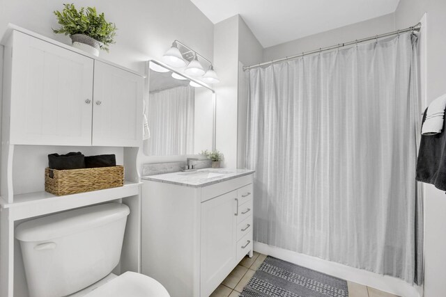 bathroom featuring a shower with shower curtain, tile patterned flooring, vanity, and toilet