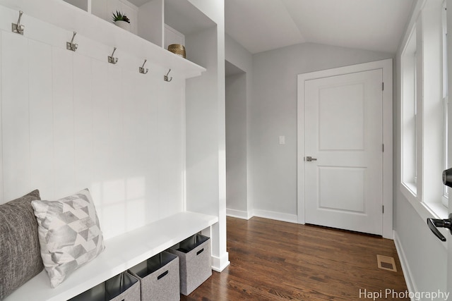 mudroom featuring vaulted ceiling, dark wood-style flooring, visible vents, and baseboards
