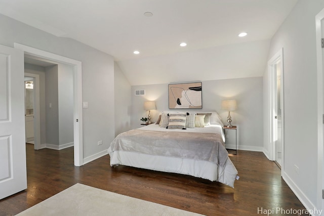 bedroom featuring vaulted ceiling, wood finished floors, visible vents, and baseboards