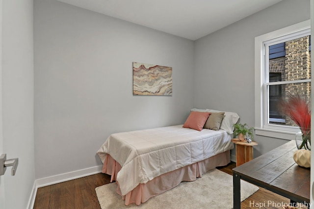 bedroom featuring baseboards and wood finished floors