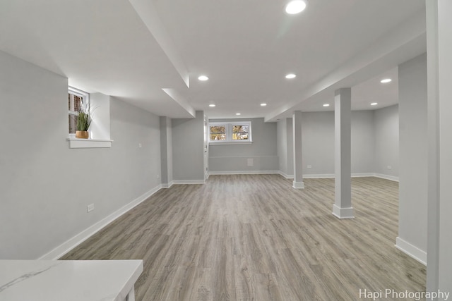 basement featuring recessed lighting, light wood-type flooring, and baseboards