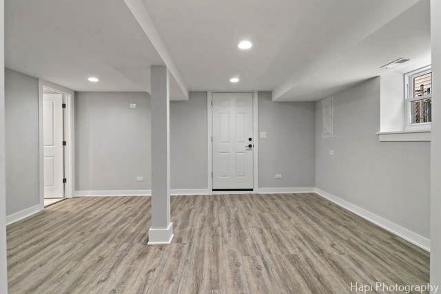 below grade area featuring recessed lighting, baseboards, visible vents, and light wood-type flooring