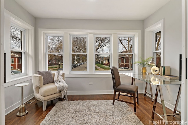 interior space with wood finished floors, a wealth of natural light, and baseboards