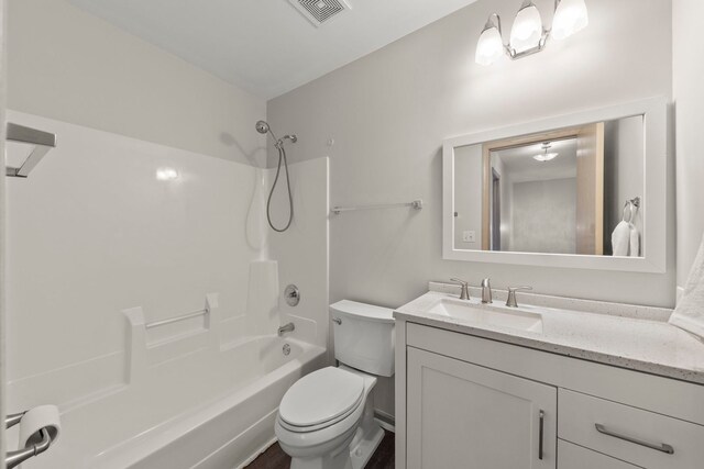 bathroom with visible vents, washtub / shower combination, toilet, and vanity