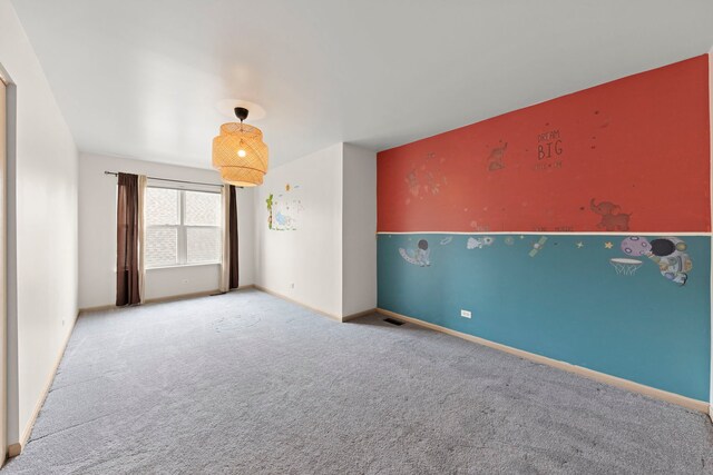 carpeted empty room with baseboards