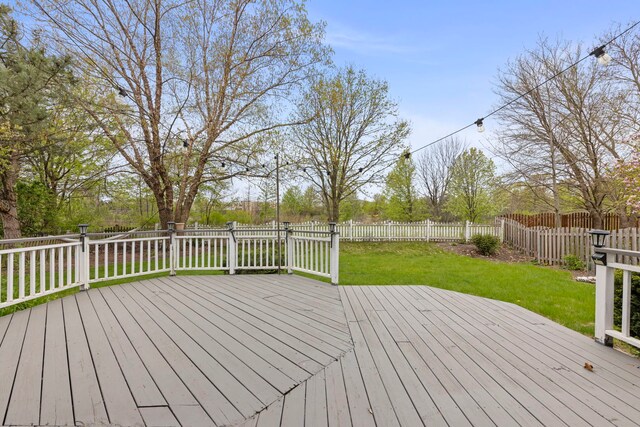 wooden deck featuring a fenced backyard and a yard