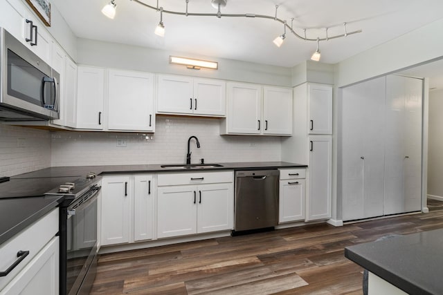 4248 Saratoga Ave Unit K102, Downers Grove, IL 60515 - kitchen featuring stainless steel appliances, a sink, dark countertops, and dark wood-style flooring