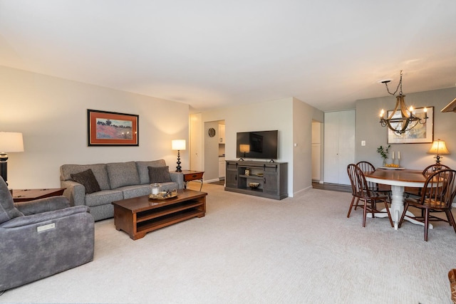 4248 Saratoga Ave Unit K102, Downers Grove, IL 60515 - living area with light carpet, baseboards, and an inviting chandelier