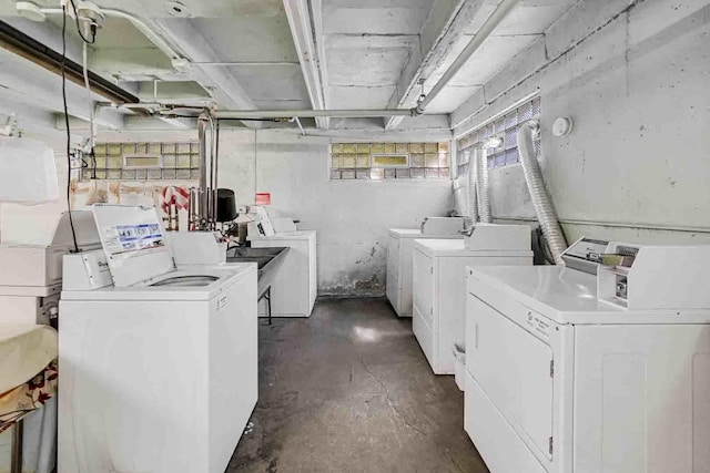 clothes washing area with washing machine and clothes dryer