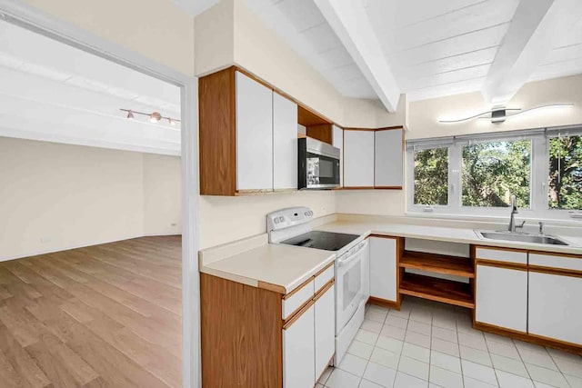 kitchen with light countertops, stainless steel microwave, beam ceiling, a sink, and white range with electric cooktop