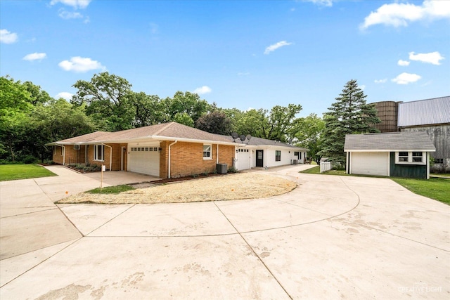 12N988 Engel Rd, Sycamore, IL 60178 - ranch-style home with an outdoor structure, brick siding, concrete driveway, an attached garage, and central air condition unit