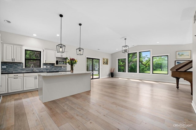 12N988 Engel Rd, Sycamore, IL 60178 - kitchen with light wood finished floors, a kitchen island, and a wealth of natural light