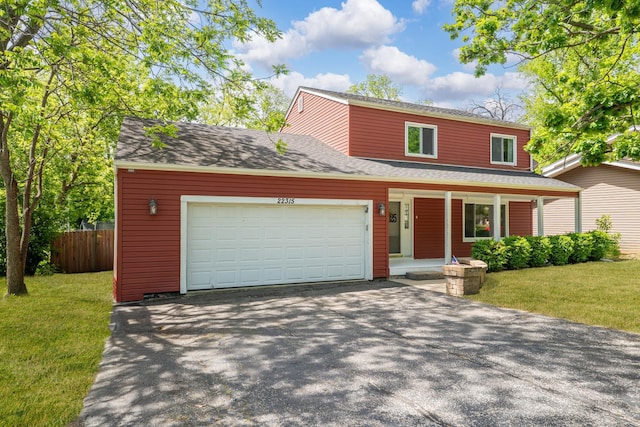 22315 W Terry Dr N, Lake Villa, IL 60046 - view of front of property featuring covered porch, driveway, a garage, and a shingled roof