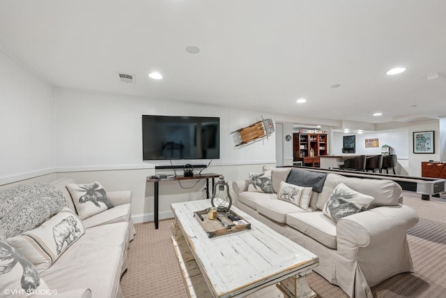 living area featuring bar, light colored carpet, visible vents, recessed lighting, and baseboards