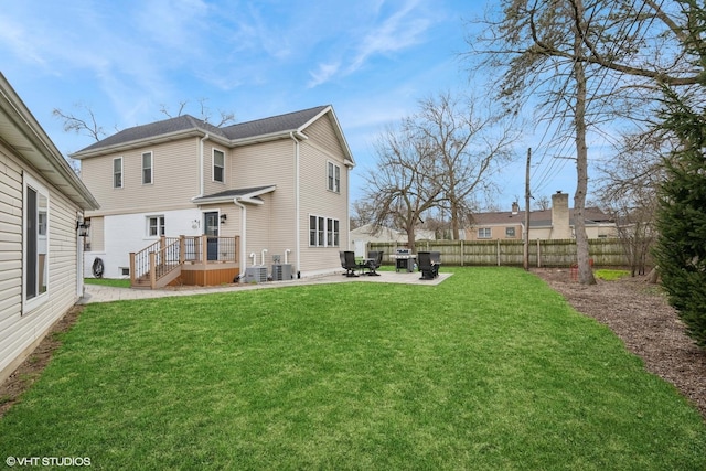 back of property with a patio area, fence, central AC unit, and a lawn