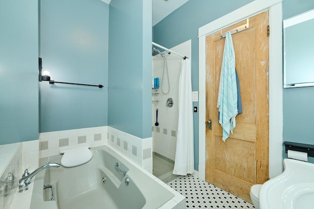 bathroom featuring a whirlpool tub and a shower stall