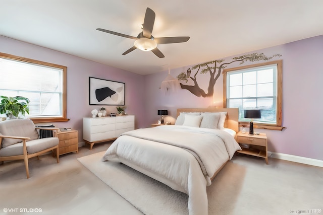 bedroom featuring baseboards, multiple windows, and a ceiling fan