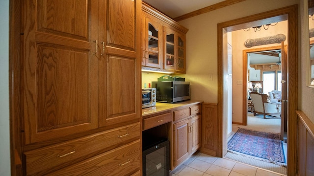 1336 Christina Ln, Northbrook, IL 60062 - kitchen with glass insert cabinets, built in desk, light countertops, stainless steel microwave, and brown cabinetry