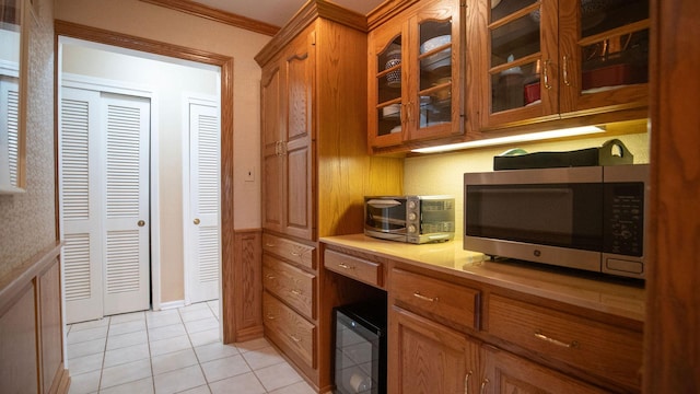 1336 Christina Ln, Northbrook, IL 60062 - kitchen featuring glass insert cabinets, light tile patterned flooring, stainless steel microwave, light countertops, and brown cabinets