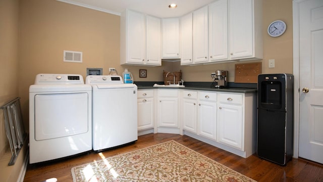 1336 Christina Ln, Northbrook, IL 60062 - laundry area featuring dark wood finished floors, visible vents, a sink, washer and dryer, and cabinet space