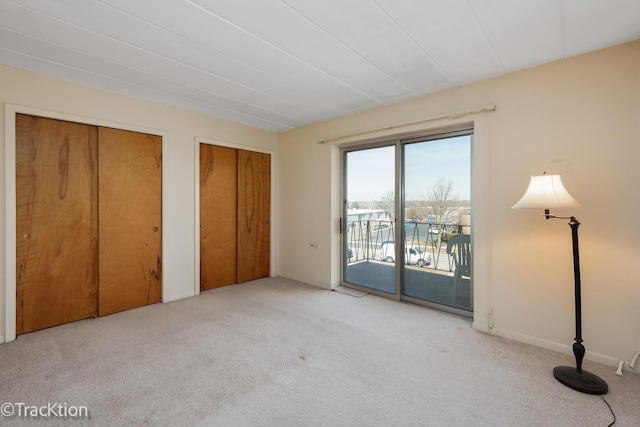 5300 Walnut Ave Unit 7C, Downers Grove, IL 60515 - unfurnished bedroom featuring access to exterior, carpet floors, and multiple closets