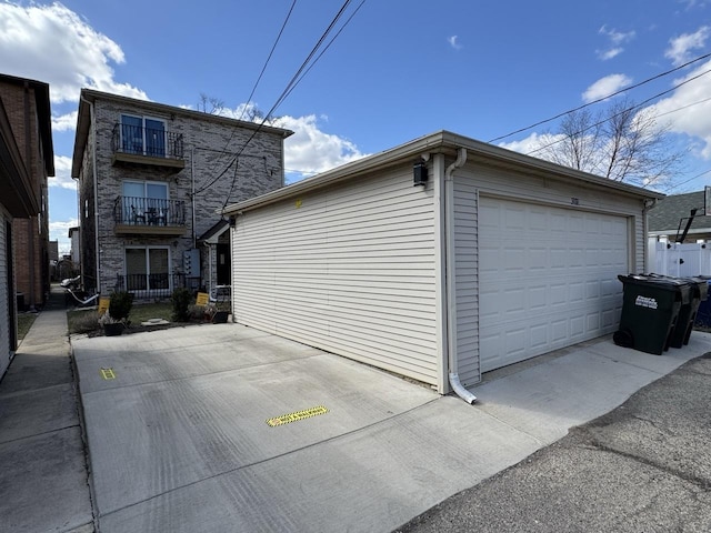 2915 N 74th Ave Unit 2, Elmwood Park, IL 60707 - view of home's exterior with stone siding, a detached garage, and an outbuilding