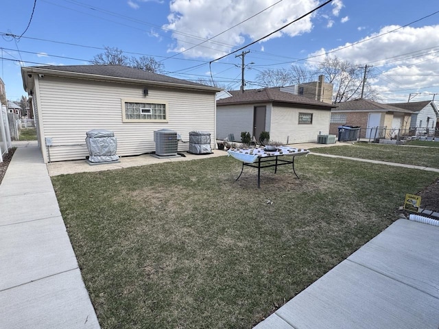 2915 N 74th Ave Unit 2, Elmwood Park, IL 60707 - back of property with central AC unit, fence, and a yard
