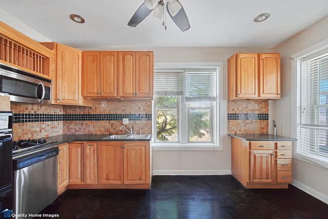 2701 W 24th Pl, Chicago, IL 60608 - kitchen with appliances with stainless steel finishes, a ceiling fan, dark countertops, decorative backsplash, and a sink
