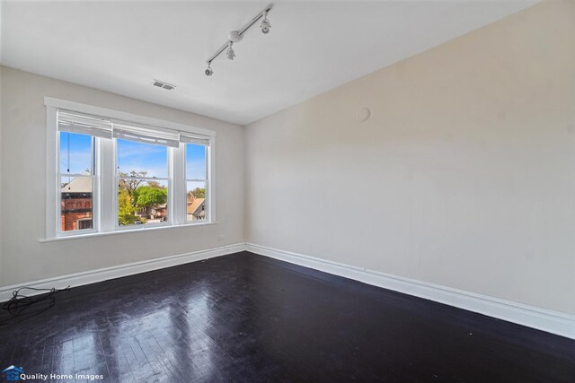 2701 W 24th Pl, Chicago, IL 60608 - empty room with visible vents, dark wood-style flooring, baseboards, and track lighting