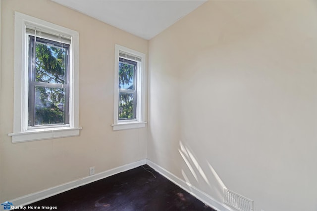 2701 W 24th Pl, Chicago, IL 60608 - spare room featuring dark wood-style flooring, baseboards, and visible vents