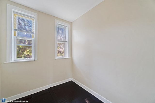 2701 W 24th Pl, Chicago, IL 60608 - unfurnished room with dark wood-style flooring, baseboards, and lofted ceiling