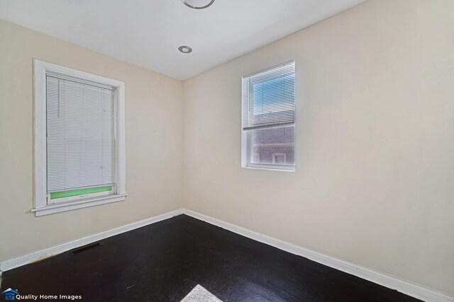2701 W 24th Pl, Chicago, IL 60608 - spare room with visible vents, baseboards, and dark wood finished floors