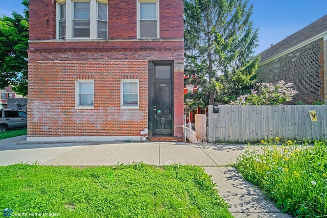 2701 W 24th Pl, Chicago, IL 60608 - doorway to property with brick siding and fence