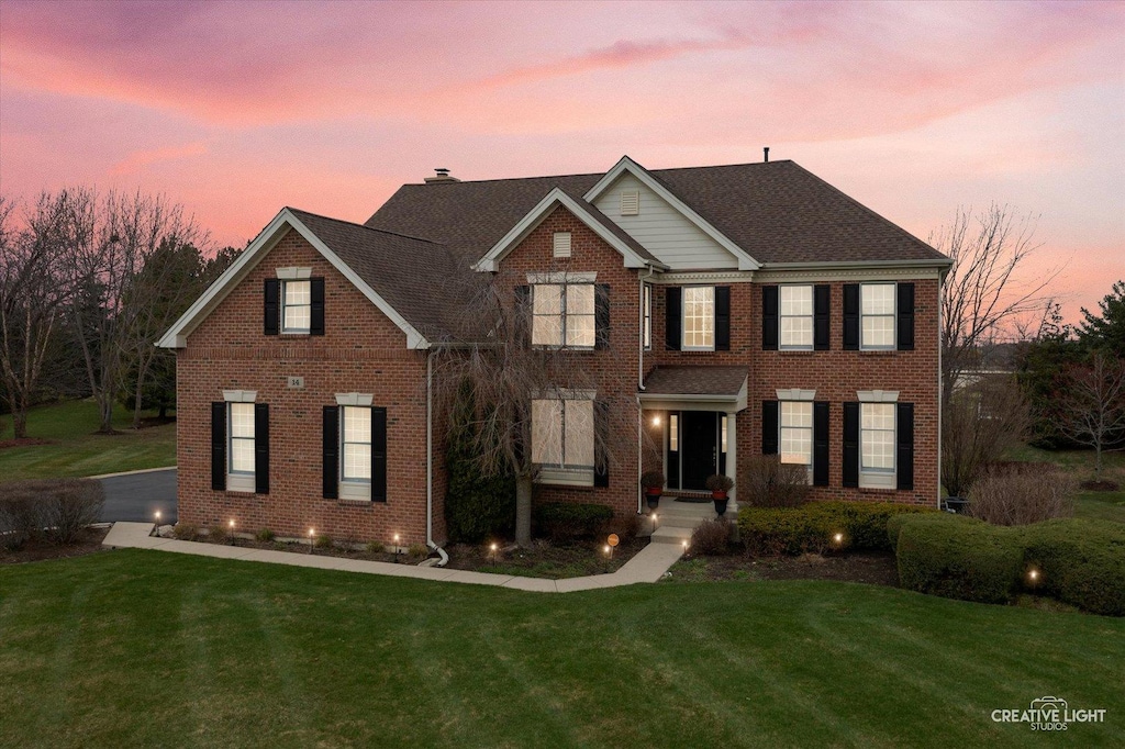 14 Twin Eagles Ct, Hawthorn Woods, IL 60047 - view of front facade with a chimney, a front lawn, and brick siding