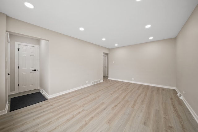 unfurnished room with recessed lighting, light wood finished floors, visible vents, and baseboards