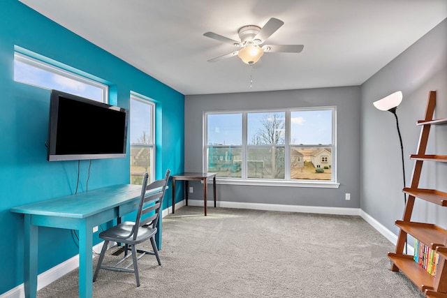 office space with carpet, baseboards, and ceiling fan