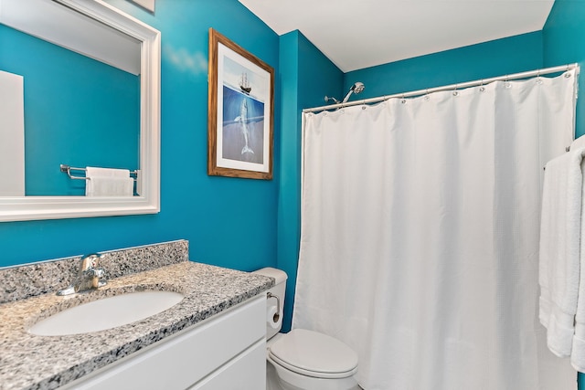bathroom featuring a shower with curtain, toilet, and vanity