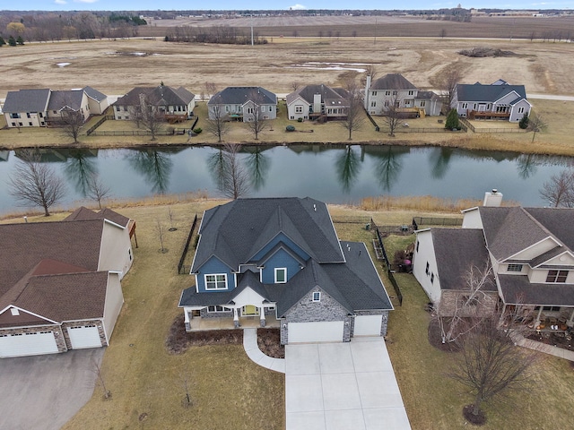 birds eye view of property featuring a residential view and a water view