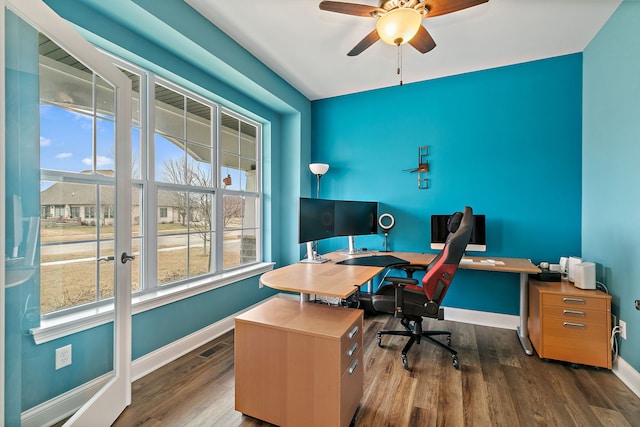 home office with baseboards, visible vents, wood finished floors, and a ceiling fan