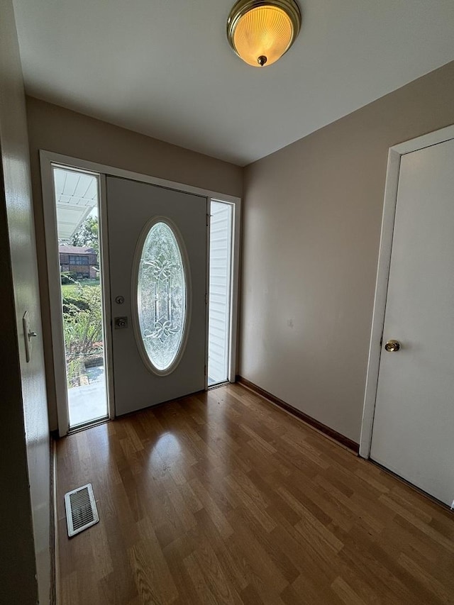 entrance foyer featuring wood finished floors and visible vents