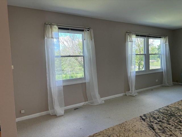 interior space featuring visible vents, carpet flooring, and baseboards