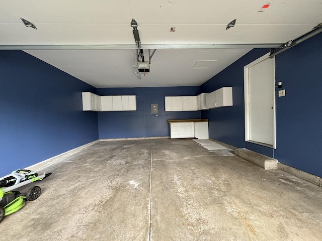 garage with baseboards and a garage door opener