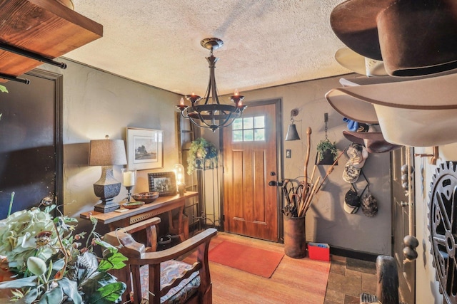 entryway featuring a textured ceiling and an inviting chandelier