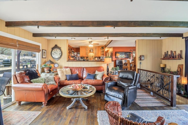 living area with beamed ceiling, a ceiling fan, and hardwood / wood-style floors