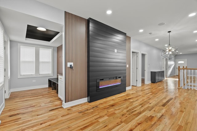 kitchen featuring a fireplace, light wood-style flooring, and recessed lighting