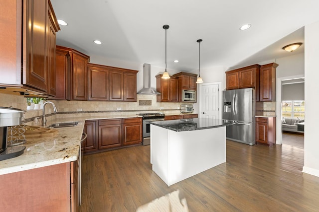 kitchen featuring a sink, wall chimney range hood, stainless steel appliances, dark wood-type flooring, and light stone counters