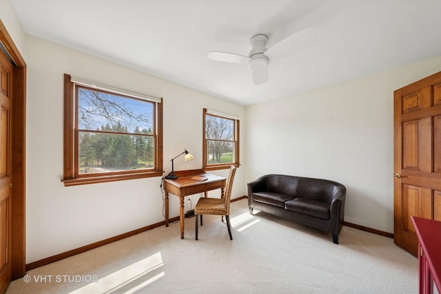 office with light colored carpet, baseboards, and a ceiling fan