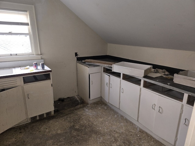 708 W Jefferson St W, Bloomington, IL 61701 - kitchen with lofted ceiling and white cabinetry
