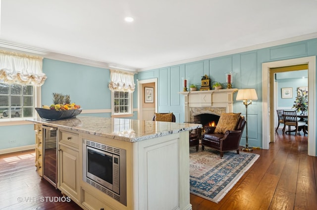 1930 Camphill Cir, Inverness, IL 60067 - kitchen featuring stainless steel microwave, dark wood-style flooring, crown molding, and light stone counters